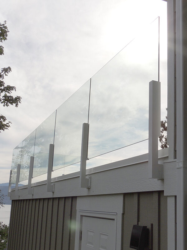 Side view of 10mil White Facia Mount Infinity Glass Deck Railing.