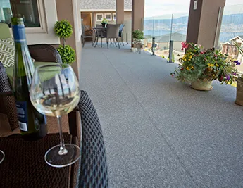 Wine glass & wine on a deck table with view of a newly installed vinyl deck
